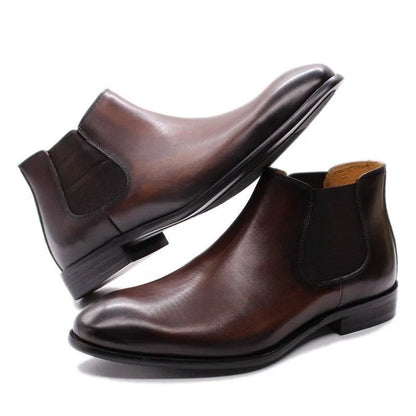Men’s brown leather ankle dress boots with elastic side panels on a white background