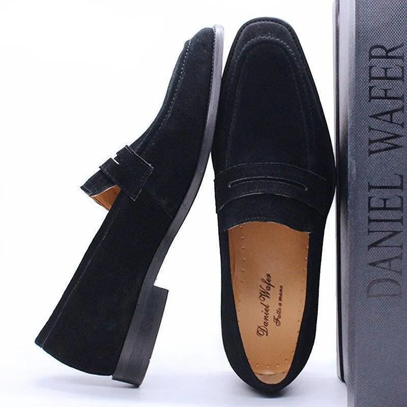 Black suede men's dress loafer shoes displayed beside a Daniel Wafer shoebox