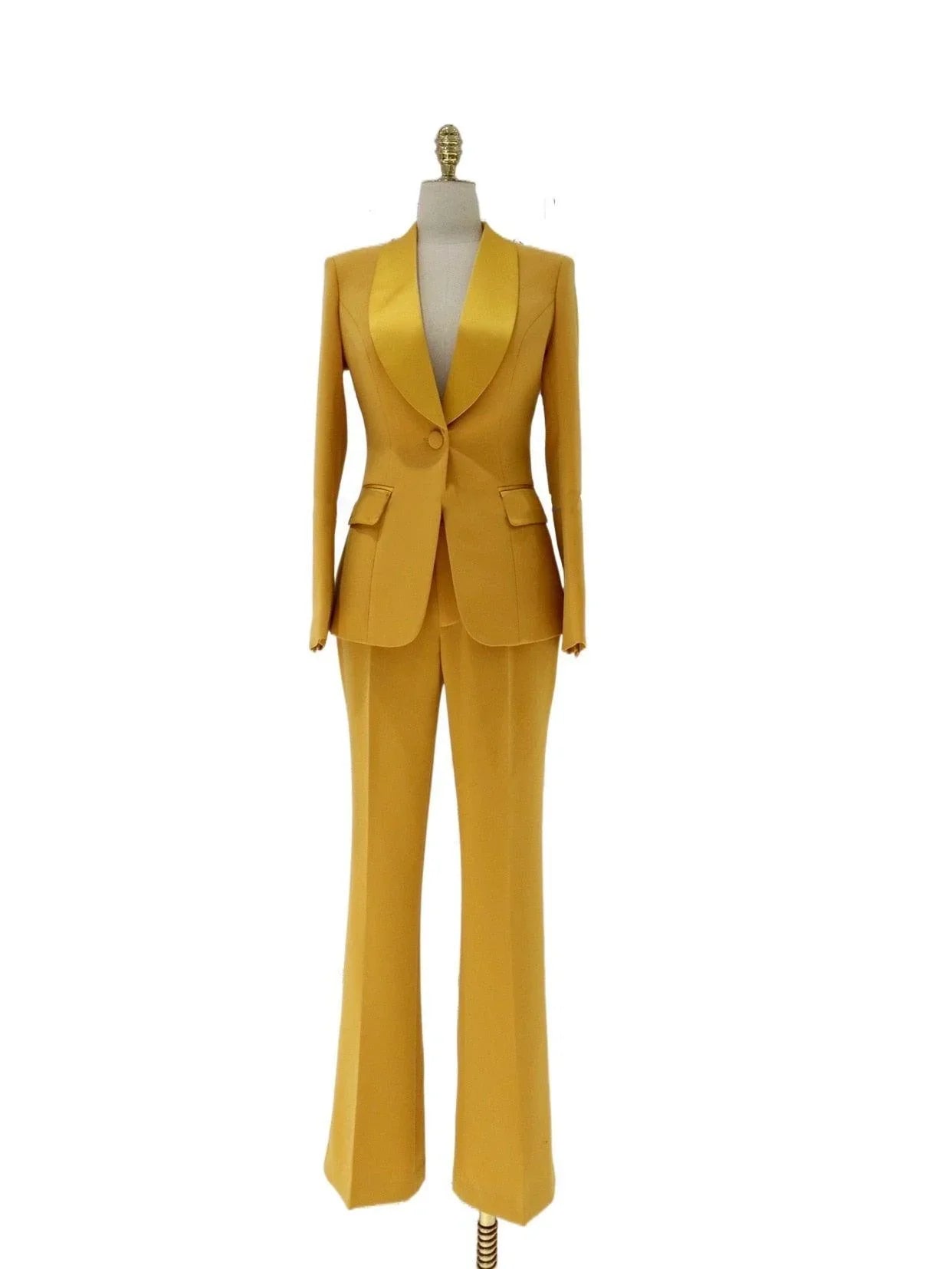 Mustard yellow satin lapel collar women’s pant suit on mannequin, tailored two piece