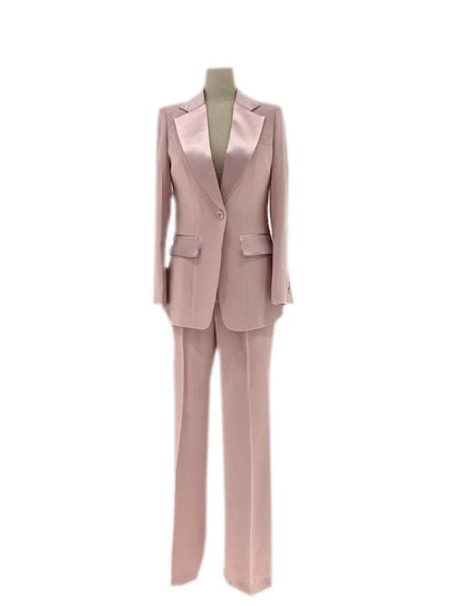 Pink silk satin women's wedding pantsuit with blazer and trousers on mannequin