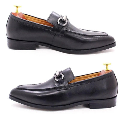 Black leather slip-on loafer shoes for men with metal buckle detail on white background