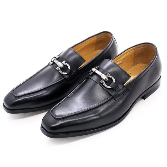Black leather slip-on loafers for men with metal buckle detail on white background