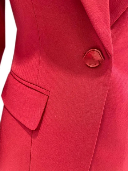 Close-up of a red women's business pantsuit with a single button and side pocket