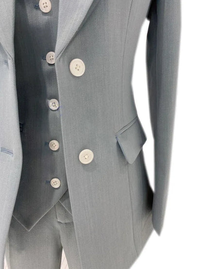 Light blue women's elegant trouser suit set with blazer and white buttons